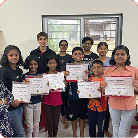 IK Aastha students proudly holding their course completion certificates