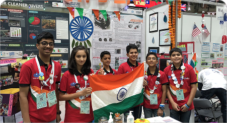 Robominds team holding the Indian flag at an international robotics competition